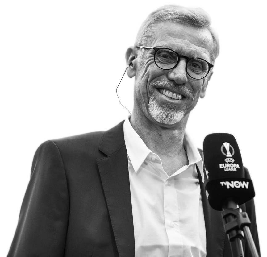 Grayscale image of Peter Stöger with microphone against a transparent background.